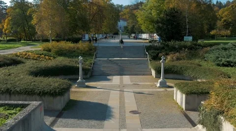 A biker leads the camera towards a beautiful park with a castle at the end Stock Footage 56242583