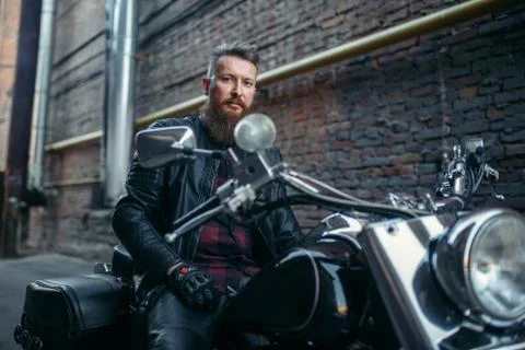 Biker in leather jacket on classical chopper Stock Photos