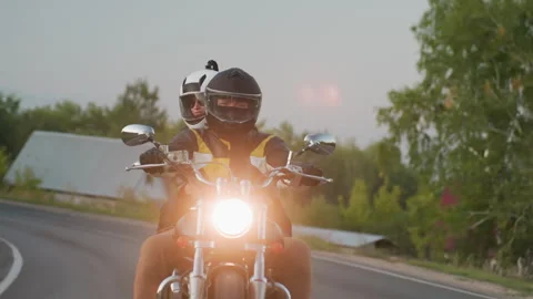 Biker Making Bend on Uphill Road with Passenger in Countryside Stock Footage 321127454
