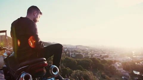 Biker man creating content for his social network taking picture of sunrise city Stock Footage 102687184