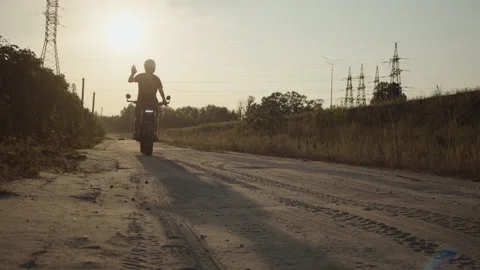 Biker Man sits and rides on the tourist motorcycle outdoor sunset Video stock 253448618