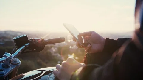 Biker man using mobile phone app and chatting outdoors connected to internet 4g Stock Footage 102746084