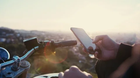 Biker man using smartphone and checking social network as nstagram or Facebook Stock Footage 102747551