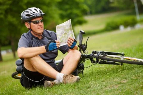 Biker with map Stock Photos
