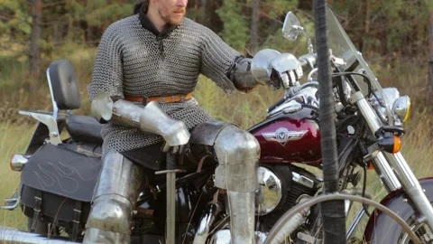 biker in medieval knight's armor sits Stock Video Pond5