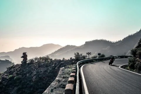 Biker on mountains Stock Photos