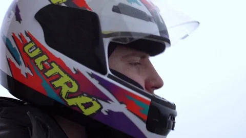 Biker puts on a helmet on a motorcycle, profile, close-up Stock Footage 73752736