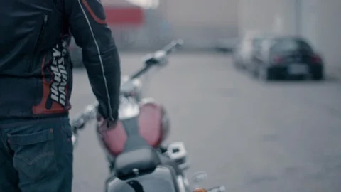 Biker ready to drive Harley-Davidson motorbike in slow motion Stock Footage 89979021