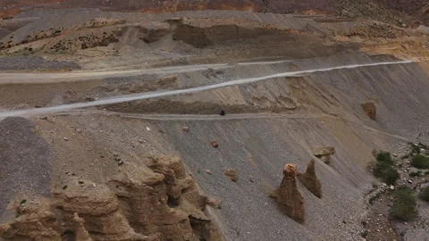 Biker rides cliffside trail drone view Stock Footage 311554096