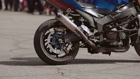 A biker rides a motorcycle standing on t... | Stock Video | Pond5