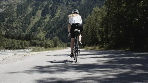 Biker riding away from camera Stock Footage 120018073