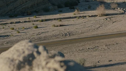 Biker riding by in the desert Stock Footage 106467316