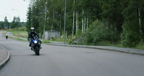 Biker riding a motorcycle in slow motion on an asphalt road Stock Footage 143209928