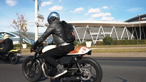 Biker riding old school cafe racer bike looking in camera Stock Footage 110912970