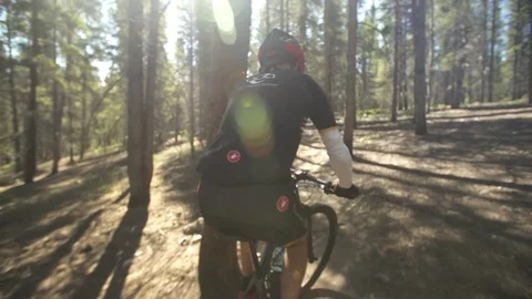 Biker Riding Through Trees On Trail 스톡 동영상 105884895