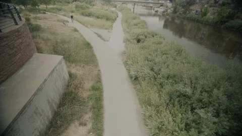 Biker Riding Under Overpass 스톡 동영상 105874149