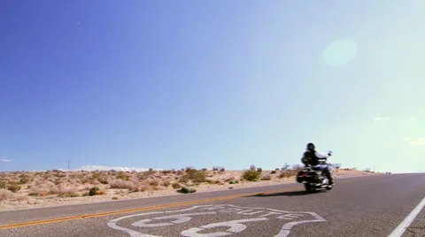 Biker on Route 66 plus sign (Cities) Stock Footage 34275395
