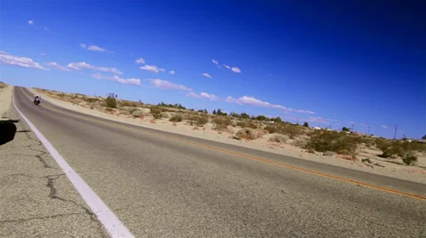 Biker on Route 66 plus sign (Cities) Stock Footage 34275453