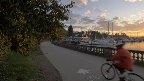 A biker on the sea wall in stanley park in Vancouver Canada Stock Footage