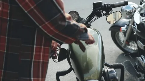 The biker sits to motorcycle Stock Footage 76850821