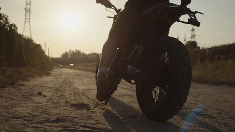 Biker is sitting on his motorcycle at off-road and starting ride. Concept of fre Stock Footage 253447392