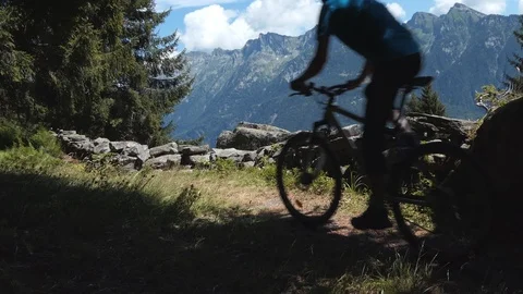 Biker stops and rests on alpine path Stock Footage 114175792