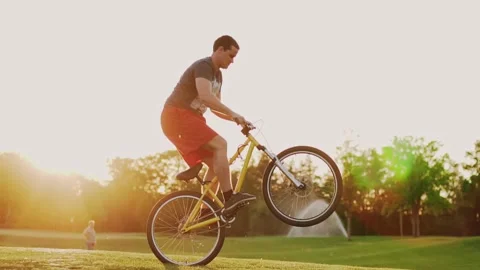 Biker stunt performer effectively performs stunts on a bicycle. Stock Footage 197851148