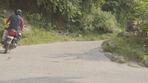 Biker taking a turn on the road Stock Footage 221737096