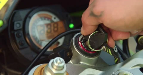 The biker turns the key in the motorcycle Video stock 157483638