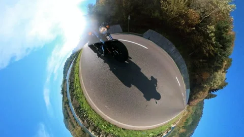 Biker in wideangle view riding highway road alone on bright sunny day. 360 Stock Footage 167922529