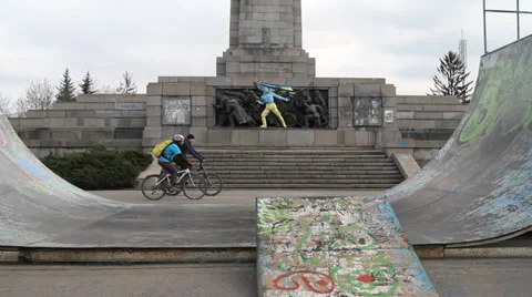 Bikers in front of a Soviet monument in Sofia painted in colours of Ukraine Stock Footage 35527602