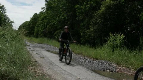 Bikers pass over the damaged road with potholes Stock Footage 158851960