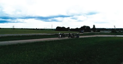 Bikers ride on a rounded road Stock-Footage 94512142