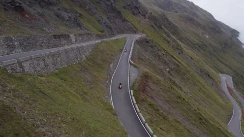 Bikers Riding On An Empty Road Overlooking A Beautiful Scenery With Mountains Video stock 252151483