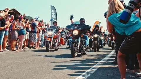 Bikers wave to the spectators right at the beginning of the motorcycle parade Stock-Footage 68645529