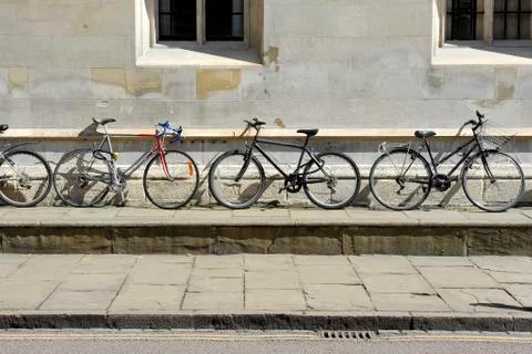 Bikes against wall Stock Photos