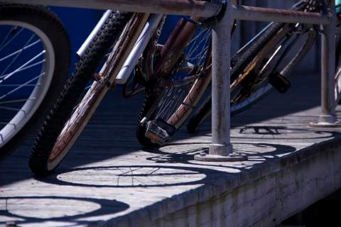 Bikes and Shadows on a boardwalk Stock Photos