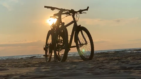 Bikes on the beach at sunset Stock Footage 113737754