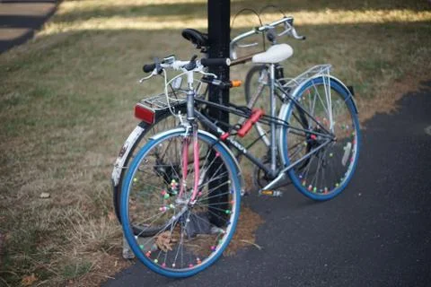 Bikes chained to pole Stock Photos