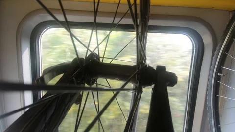 Bikes hanging on rack in moving train, town in window Stock Footage 114646760