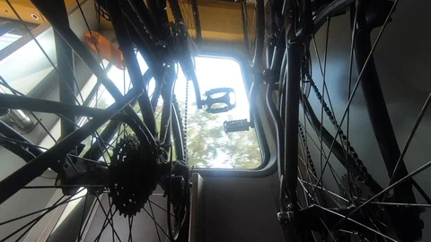 Bikes hanging on rack in train, outside activities concept Stock Footage 114632297
