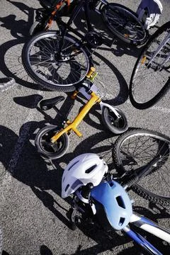 Bikes with helmets on the ground Stock Photos
