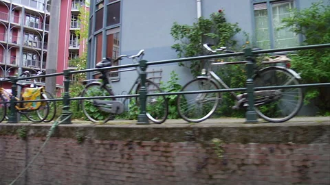 Bikes leaning against a railing Stock Footage 241348217