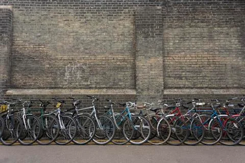 Bikes lined up against a wall Stock Photos