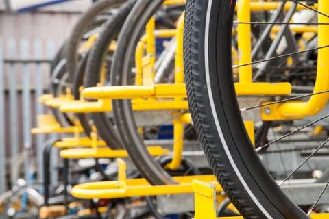 Bikes lined up in the store in yellow rack Stock Photos