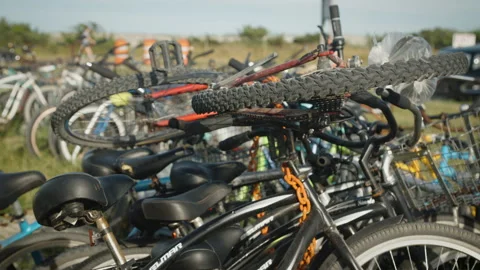 Bikes at park overflowing and stacked on top of one another Stock Footage