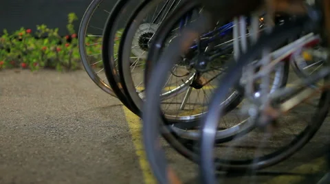 Bikes Parked in a Row Reflect Surrounding Light Stock Footage 61438973