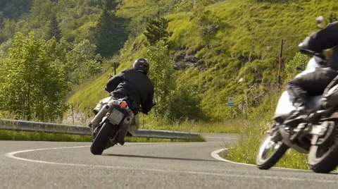 Bikes pass by low Stock Footage 1043080