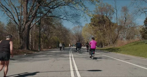 Bikes Riding Down the Path in a City Park Video stock 152350940