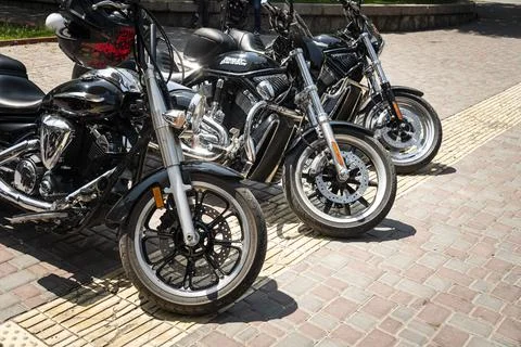 Bikes in a row. several large American Harley Davidson motorcycles stand in a Stock Photos